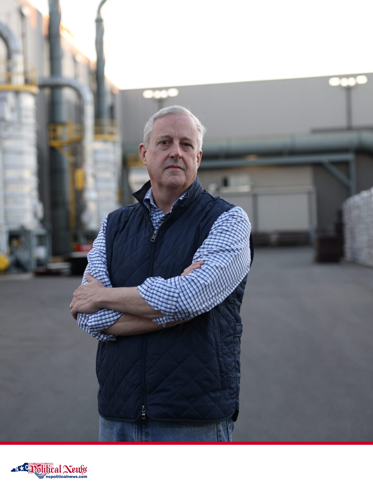 Michael Whatley stands with folded arms at an industrial facility.
