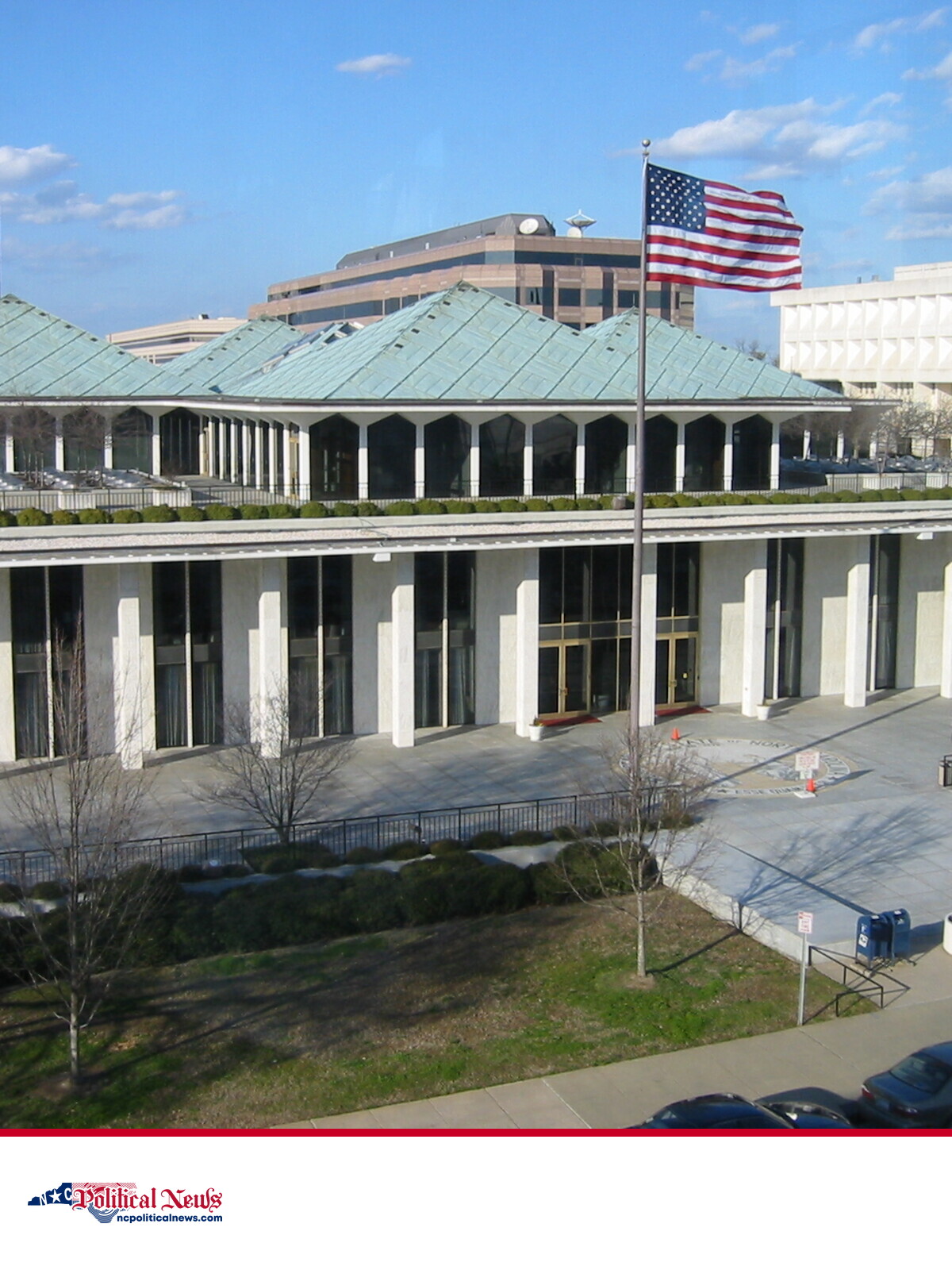 North Carolina State Legislative Office Building in Raleigh with the U.S. and North Carolina flags in front.
