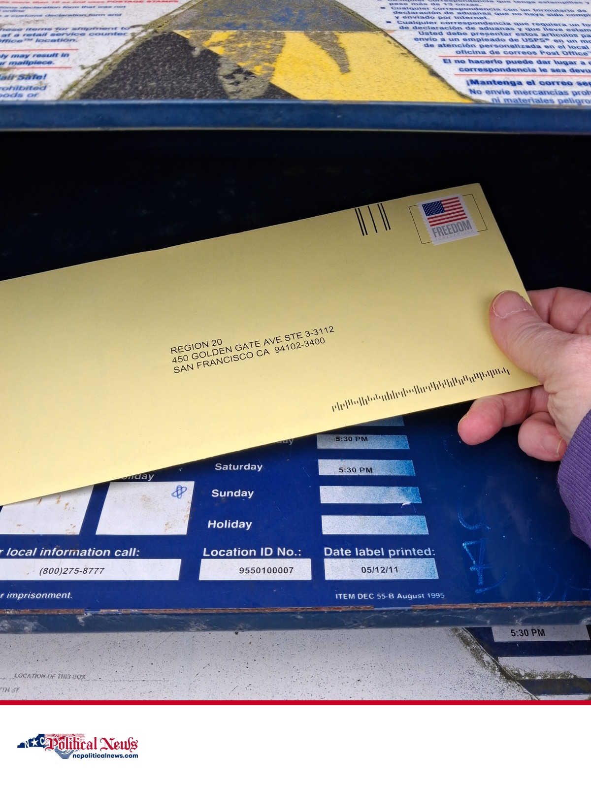 A completed mail ballot in an envelope being placed into a U.S. Postal Service collection box, shown as contextual file imagery.