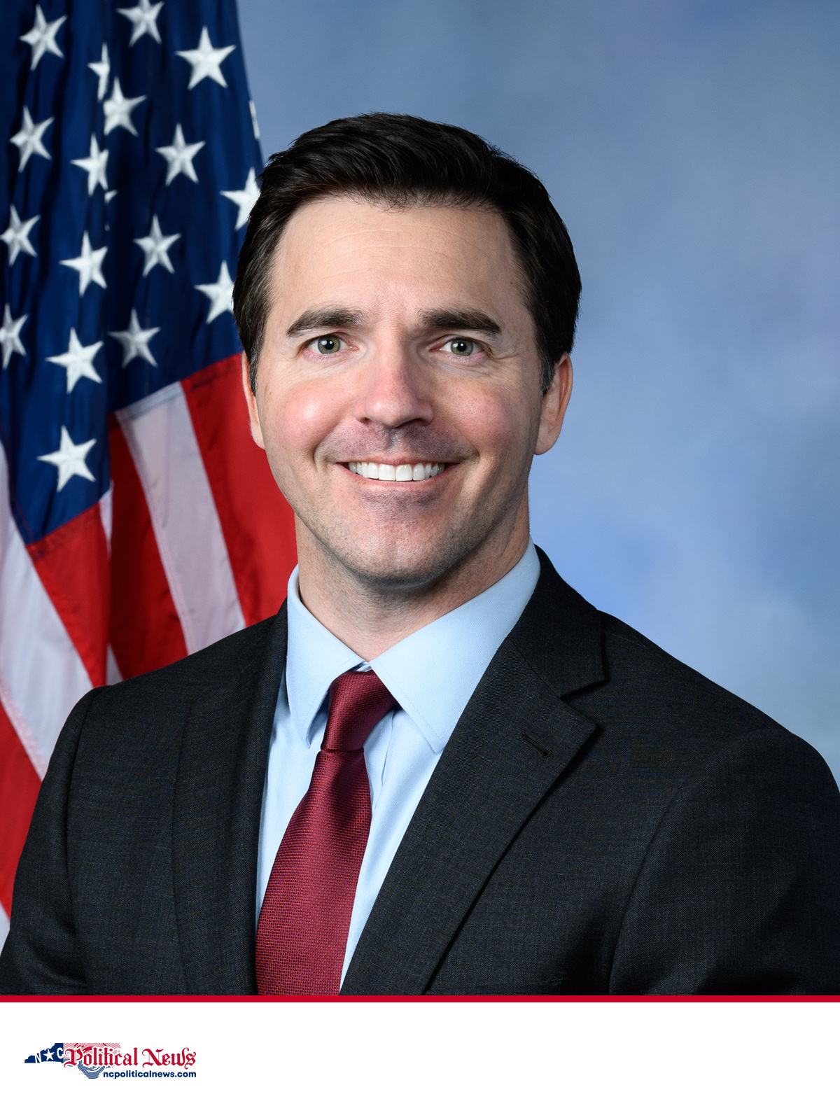 North Carolina Attorney General Jeff Jackson in an official portrait with the U.S. flag behind him.